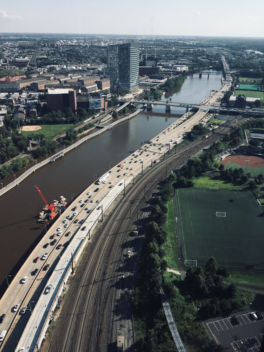 vehicles on highway beside body of water during daytime